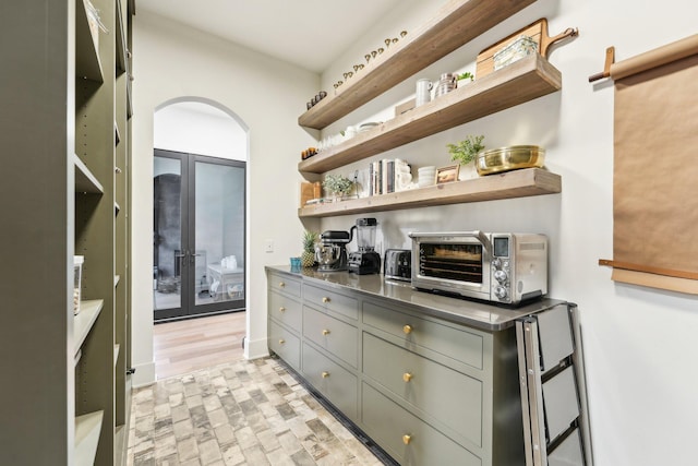 bar with a toaster, arched walkways, and baseboards