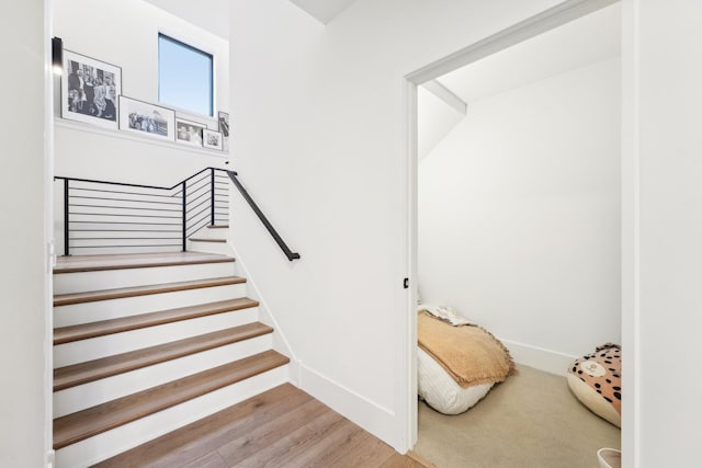 stairs featuring baseboards and wood finished floors