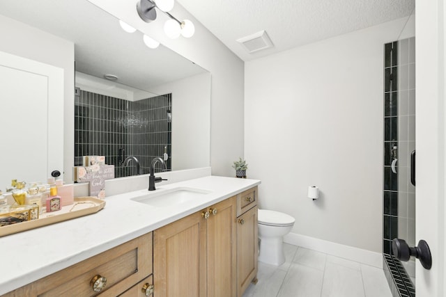 full bathroom with baseboards, toilet, tiled shower, tile patterned floors, and vanity