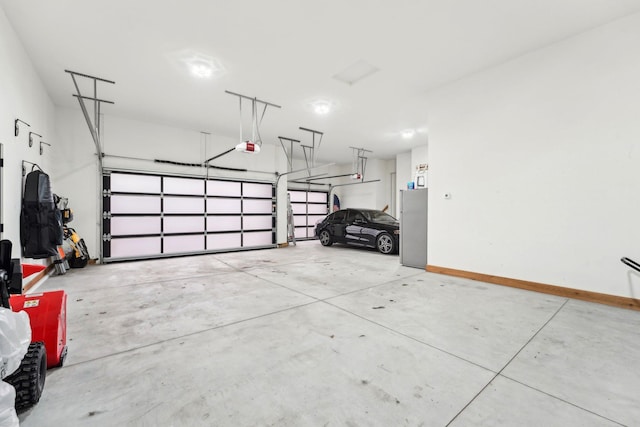 garage with a garage door opener and baseboards