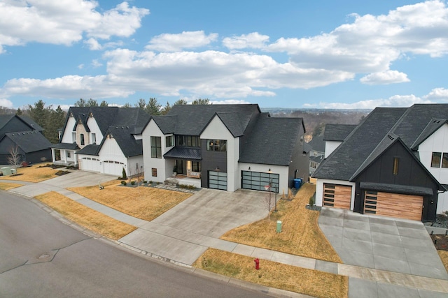 modern farmhouse style home with a residential view, driveway, and roof with shingles