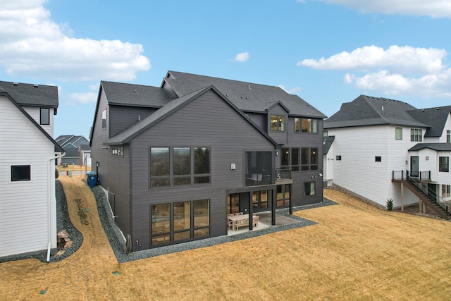 back of house featuring a yard and a patio