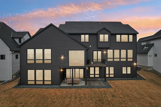 back of house with a yard, a patio, and central AC unit