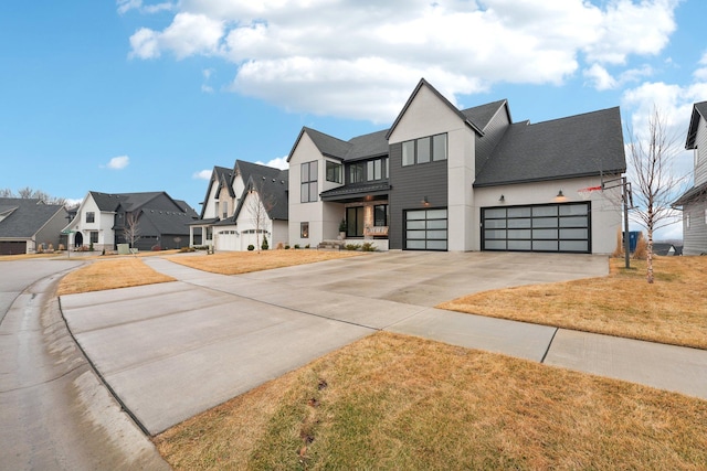 view of front of house with a residential view, concrete driveway, a front yard, stucco siding, and a balcony