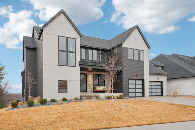 view of front of property with a garage, a front yard, driveway, and a shingled roof