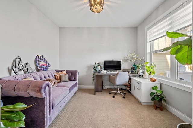 office featuring baseboards and light colored carpet