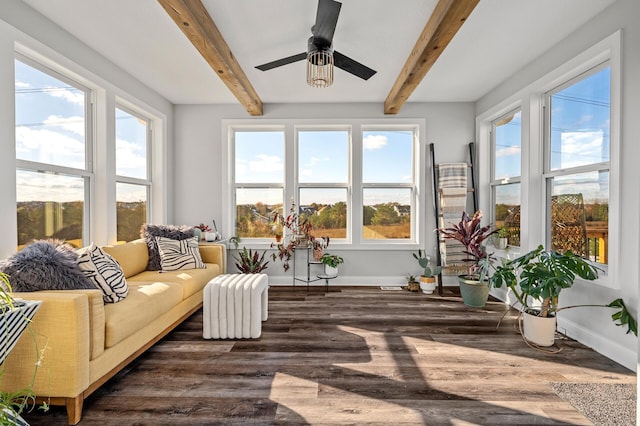 sunroom / solarium featuring ceiling fan and beam ceiling