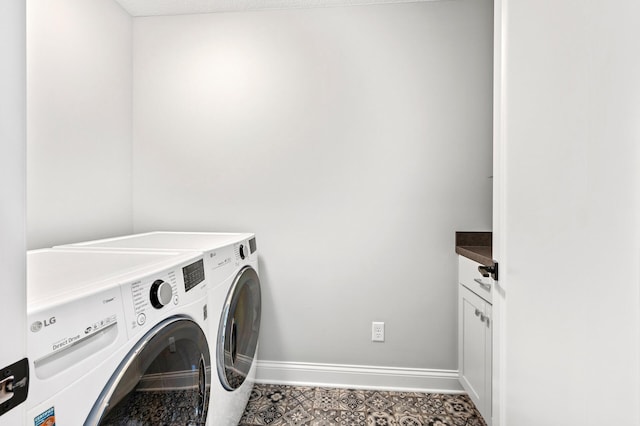 laundry area with baseboards, cabinet space, and washing machine and clothes dryer