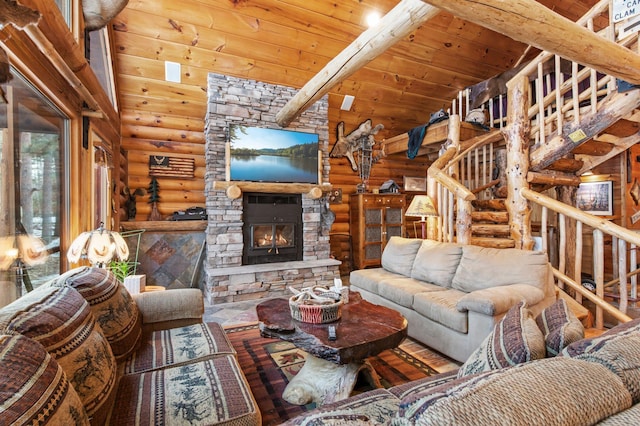 living area featuring lofted ceiling, wood ceiling, a fireplace, and stairway