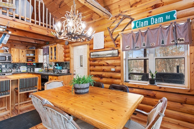dining room with wood ceiling, beam ceiling, light wood-style flooring, and an inviting chandelier