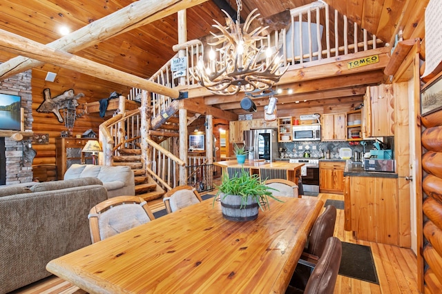 dining room featuring wooden ceiling, light wood-style flooring, stairway, beamed ceiling, and a chandelier