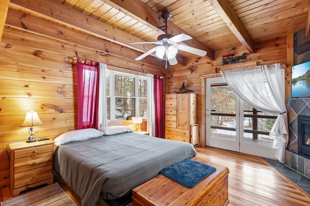 bedroom with wood ceiling, access to outside, light wood-style flooring, and wooden walls