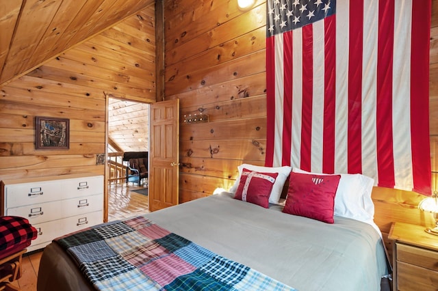 bedroom featuring wood walls