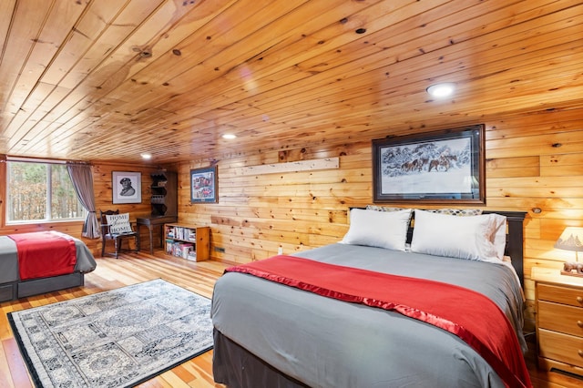 bedroom with wood walls, recessed lighting, wood ceiling, and light wood-style floors