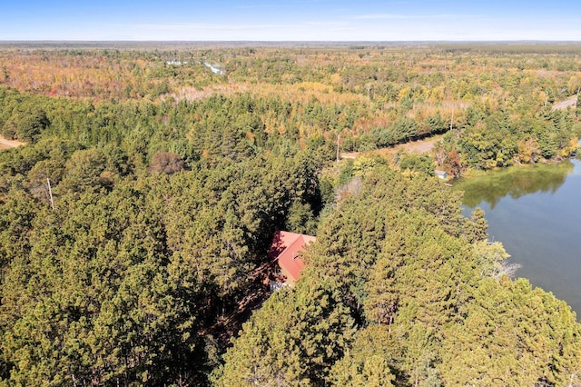 aerial view with a water view and a forest view