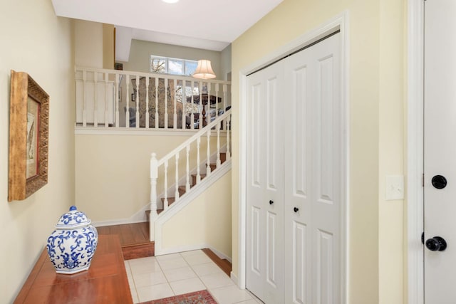 staircase featuring tile patterned flooring and baseboards