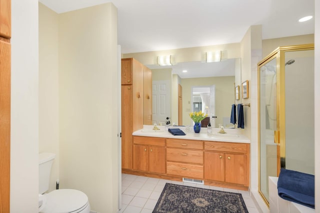 full bath featuring double vanity, tile patterned flooring, a stall shower, and a sink