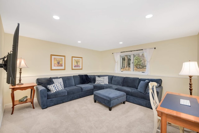 carpeted living area with baseboards and recessed lighting