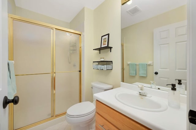 bathroom featuring vanity, toilet, visible vents, and a stall shower
