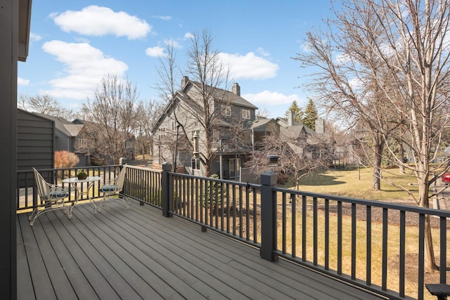 wooden terrace featuring a yard and a residential view