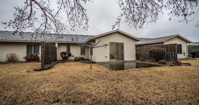 rear view of property with a yard and a patio area