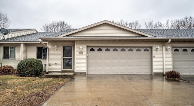 single story home with a garage, concrete driveway, and roof with shingles