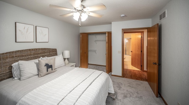 carpeted bedroom featuring a ceiling fan, a closet, visible vents, and baseboards