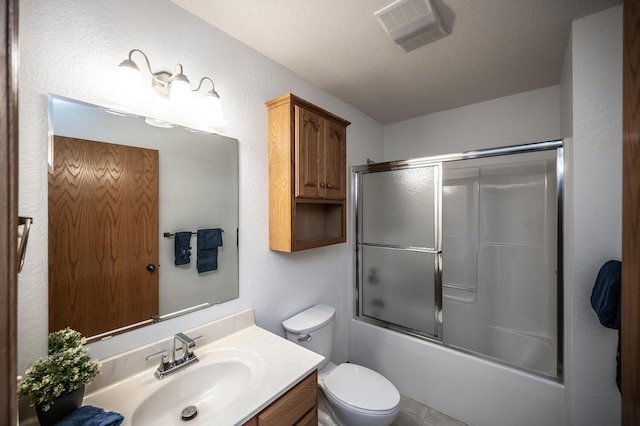 full bath featuring a textured ceiling, toilet, shower / bath combination with glass door, vanity, and visible vents