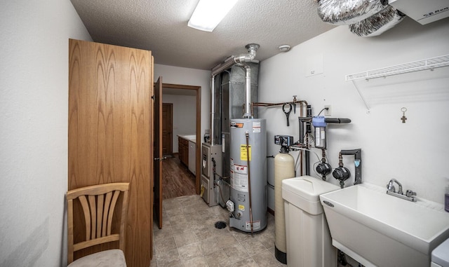 utility room featuring water heater and a sink