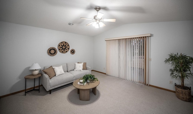 carpeted living area with a ceiling fan, lofted ceiling, and baseboards