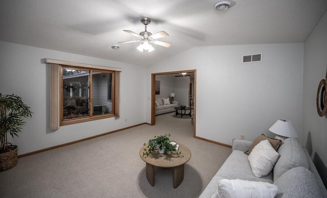 carpeted living area featuring visible vents, vaulted ceiling, baseboards, and ceiling fan