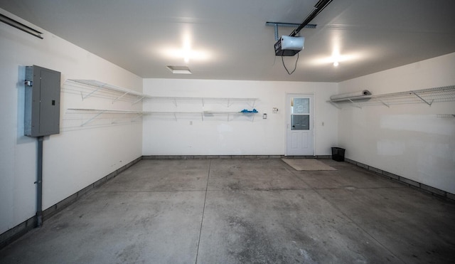 garage featuring electric panel and a garage door opener