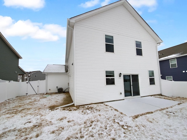 rear view of property with central air condition unit, a gate, fence, and a patio