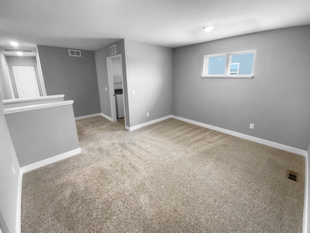 carpeted empty room featuring visible vents and baseboards