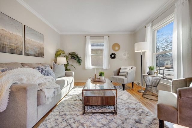 living area featuring crown molding, baseboards, a wealth of natural light, and wood finished floors