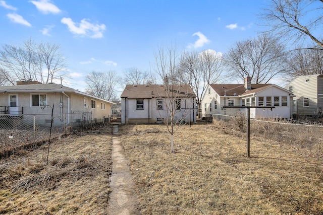 back of property featuring fence