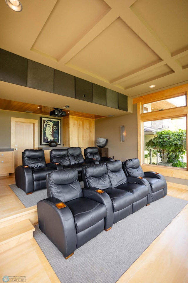 cinema room with coffered ceiling, beamed ceiling, and wood finished floors
