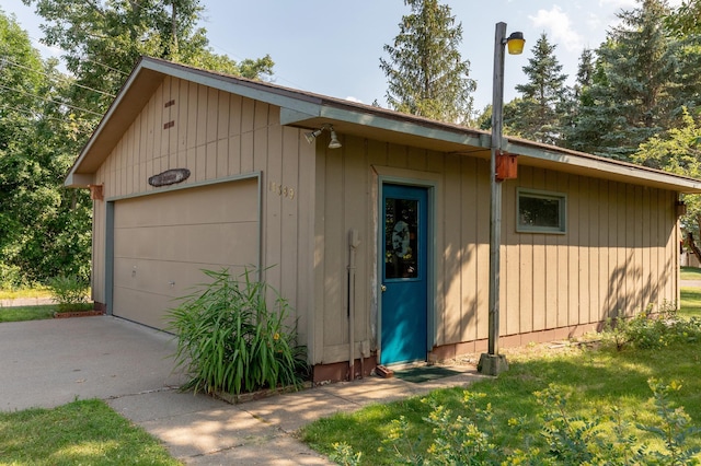 detached garage with concrete driveway