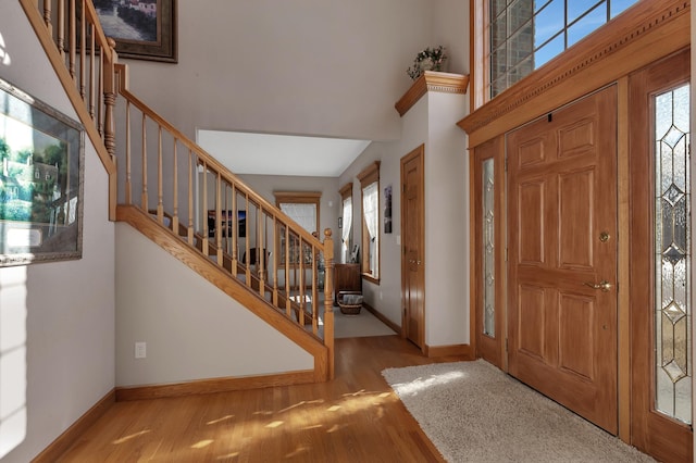 617 17th St N, Sartell, MN 56377 - foyer featuring stairway, a towering ceiling, baseboards, and wood finished floors