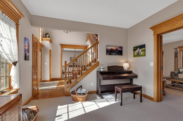 617 17th St N, Sartell, MN 56377 - sitting room with baseboards, carpet, stairway, and a chandelier