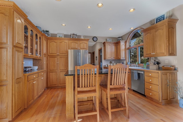 617 17th St N, Sartell, MN 56377 - kitchen featuring stainless steel appliances, light wood-type flooring, glass insert cabinets, recessed lighting, and a sink