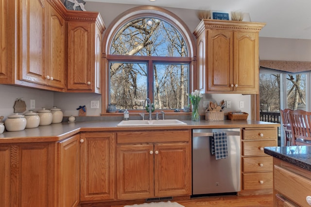 617 17th St N, Sartell, MN 56377 - kitchen with stainless steel dishwasher, a sink, and brown cabinetry