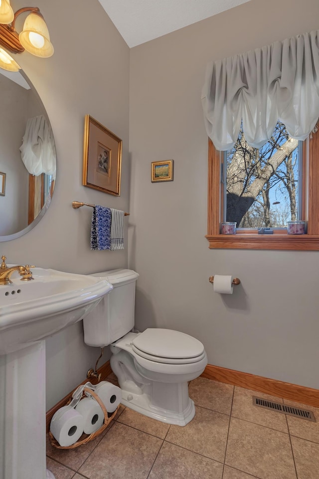 617 17th St N, Sartell, MN 56377 - half bathroom with toilet, tile patterned floors, and baseboards