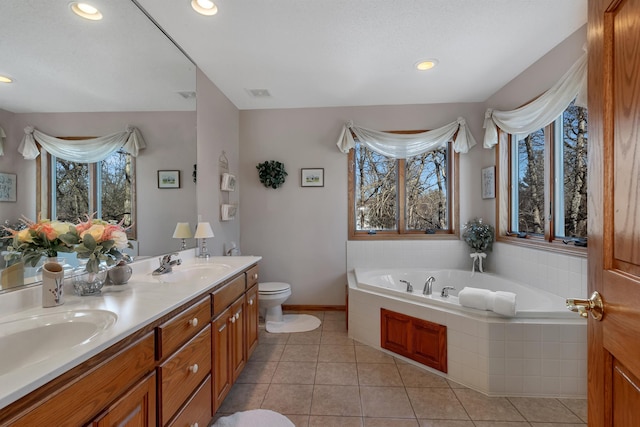 617 17th St N, Sartell, MN 56377 - bathroom with toilet, a bath, double vanity, baseboards, and tile patterned floors