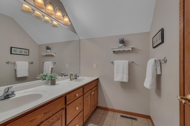 617 17th St N, Sartell, MN 56377 - bathroom featuring vaulted ceiling, double vanity, tile patterned floors, and baseboards