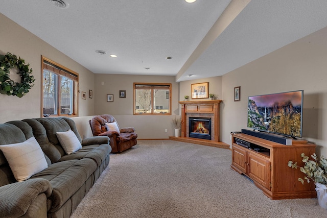 617 17th St N, Sartell, MN 56377 - living room with light colored carpet, a glass covered fireplace, recessed lighting, and baseboards