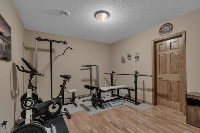617 17th St N, Sartell, MN 56377 - workout area featuring light wood-style flooring and a textured ceiling