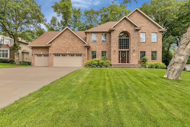 617 17th St N, Sartell, MN 56377 - traditional home featuring brick siding, a front yard, an attached garage, concrete driveway, and roof with shingles