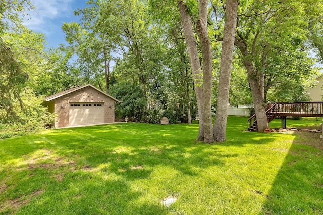 617 17th St N, Sartell, MN 56377 - view of green lawn featuring a garage, a deck, an outbuilding, and stairs