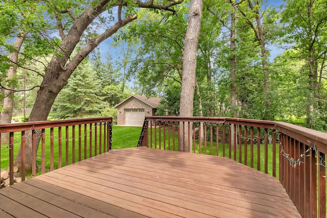 617 17th St N, Sartell, MN 56377 - deck featuring a lawn, an outdoor structure, and a detached garage
